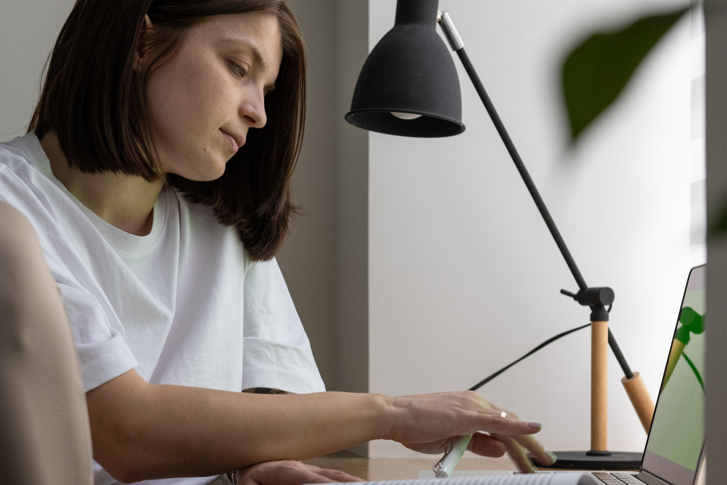 A woman sitting at her desk with a lamp